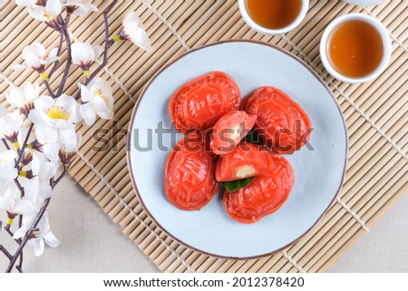 Kue Ku or tok cake or red turtle cake is Indonesian traditional cake from Chinese culture made from glutinous rice and sweet green bean inside, in the shape of a turtle shell. Selective focus. Royalty-Free Stock Photo #2012378420