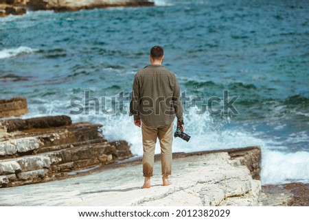 professional photographer shooting seascape. copy space