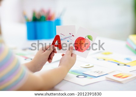 Kids learn to read. Colorful abc phonics flash cards for kindergarten and preschool children. Remote learning and homeschooling for young kid. Child reading sounds and letters. English lesson. Royalty-Free Stock Photo #2012391830