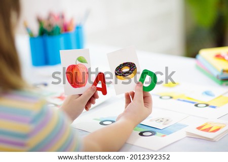 Kids learn to read. Colorful abc phonics flash cards for kindergarten and preschool children. Remote learning and homeschooling for young kid. Child reading sounds and letters. English lesson. Royalty-Free Stock Photo #2012392352
