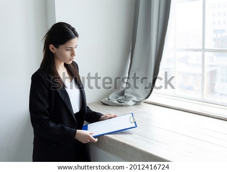 beautiful brunette working near the window