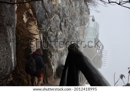 Traveller in the natural view with cloudy fog and mountain scene in the area of ZhangJiajie 