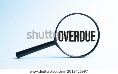 Magnifying glass with the word OVERDUE. Business concept