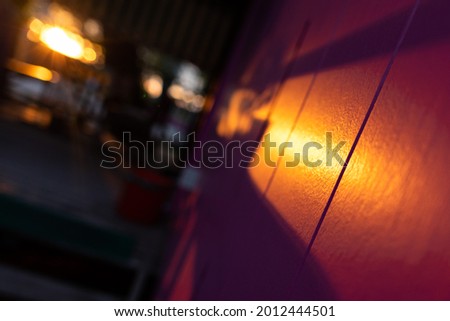 Wooden magenta surface lit by sundown light, perspective creative view, blurred background, 