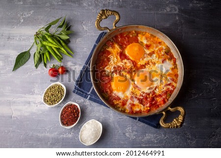 Famous Turkish menemen dinner on table, made by eggs, pepper and tomatoes. Royalty-Free Stock Photo #2012464991