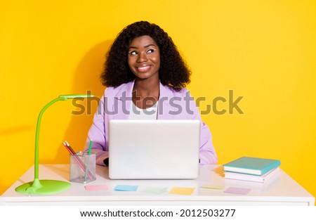 Photo of young smiling dreamy businesswoman work in laptop look copyspace isolated on yellow color background