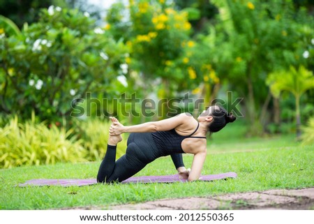 woman young adult Asian practicing yoga at home garden nature to relax and get healthy health social distancing. Sport and recreation stock photo