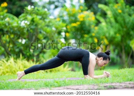 woman young adult Asian practicing yoga at home garden nature to relax and get healthy health social distancing. Sport and recreation stock photo