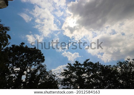 Stratocumulus clouds with a clear blue sky and Tree silhouette background in the midday. Types of clouds stock images.