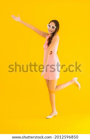Portrait beautiful young asian woman smile happy on yellow isolated background