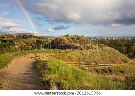 Boise Idaho neighborhood skyline and trail on the hill with rainbow after rain during Summer. View from Camels Back Park. Royalty-Free Stock Photo #2012615936