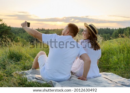 Beautiful adult couple together taking selfie photo on smartphone