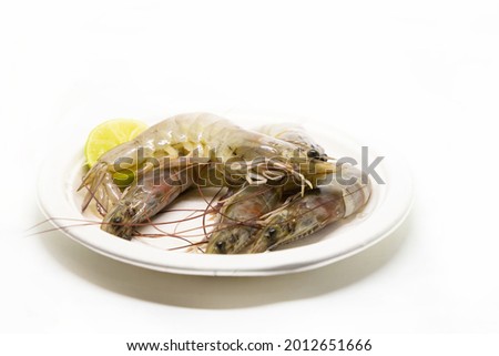 gray tiger prawns on a plate fresh seafood with lemon wedge