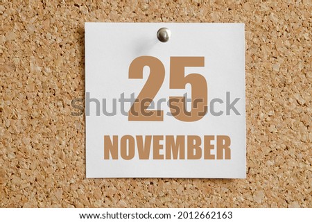 november 25. 25th day of the month, calendar date.White calendar sheet attached to brown cork board.Autumn month, day of the year concept