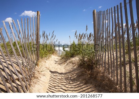 Entrance to the beach over sand dunes  Royalty-Free Stock Photo #201268577