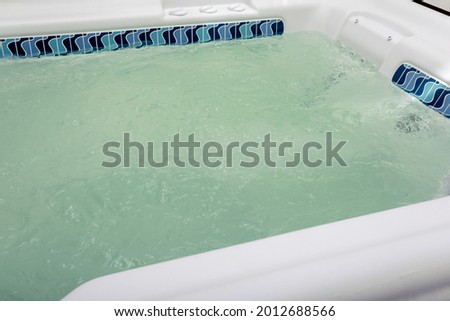 bubbling water in hot tub with hydromassage close-up, spa background, copy space. High quality photo