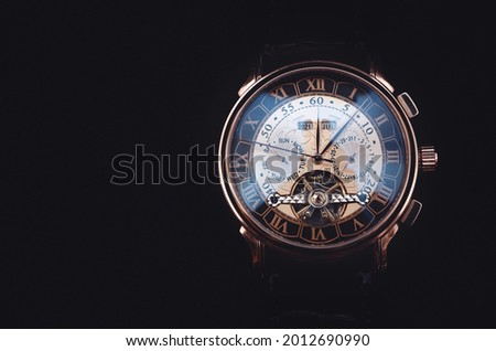 Mechanical watch on a black background. Men's watches, stock photo for the inscription