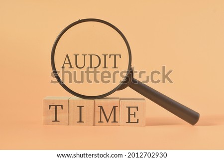 Audit Time wording with magnifying glass. Business concept