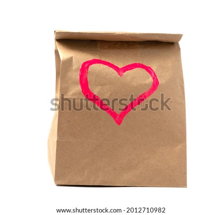 kraft paper bag with red heart pattern. concept of discounts and gifts. copy space.