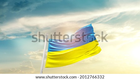 Ukraine national flag waving in beautiful clouds. Royalty-Free Stock Photo #2012766332