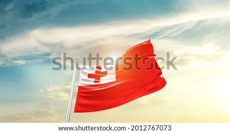 Tonga national flag waving in beautiful clouds.