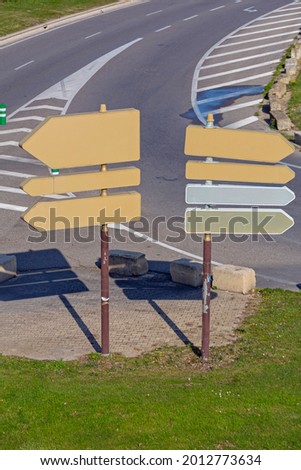 Two Traffic Sign Poles With Directional Arrows in France