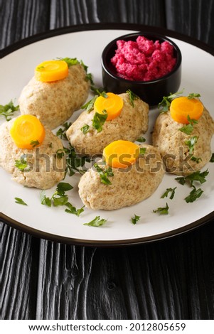 Jewish Gefilte Fish Recipe with Beet Horseradish closeup in the plate on the tble. Vertical
