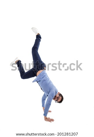 young hispanic man with blue shirt and glasses doing a cartwheel isolated over white