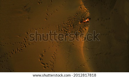 woman stretching in desert photographed with drone