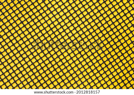 Black mesh on the yellow poster board background