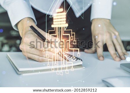 Creative light bulb illustration with microcircuit and hand writing in diary on background with laptop, future technology concept. Multiexposure