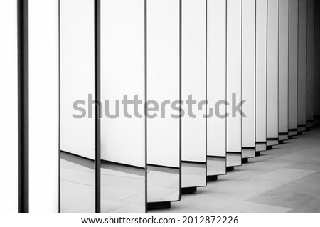 Wall of endless mirrors that reflect infinity and creates a repetitive pattern background, shot black and white in Paris, France.