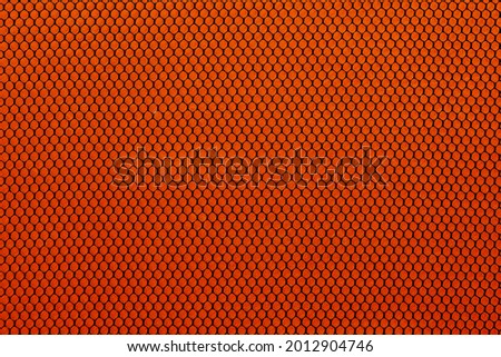 Black mesh texture isolated on orange background