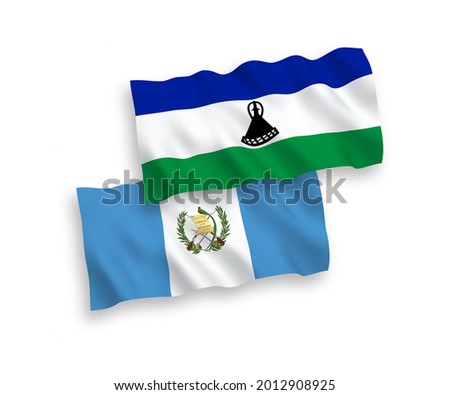 National vector fabric wave flags of Republic of Guatemala and Lesotho isolated on white background. 1 to 2 proportion.