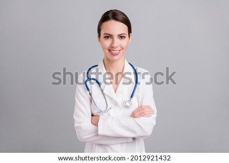 Photo of confident charming young lady doctor workwear hands folded isolated grey color background