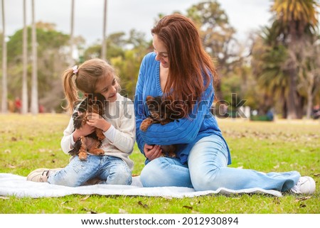 Yorkshire Terrier puppy in the arms of happy family