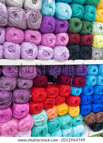 Skeins of multicolored thread for needlework close-up. Background image, sewing, embroidery, handmade, hobby, DIY concept.