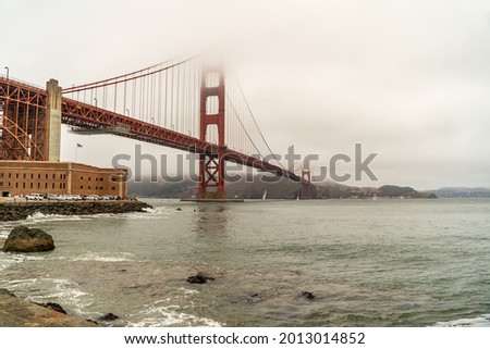 The famous Golden Gate Bridge in the fog. View from the south coast, from the Fort Point embankment.