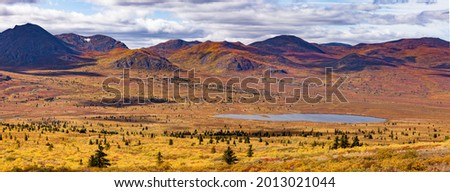Panoramic autumn fall colored alpine tundra of Bonneville mountain range remote wilderness landscape, Yukon Territory, YT, Canada Royalty-Free Stock Photo #2013021044