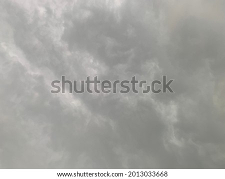 Nimbostratus Clouds A gray Style rolls are round to each other in sheets or layers and Huge scary storm it's going to rain heavily at Thailand.no focus Royalty-Free Stock Photo #2013033668