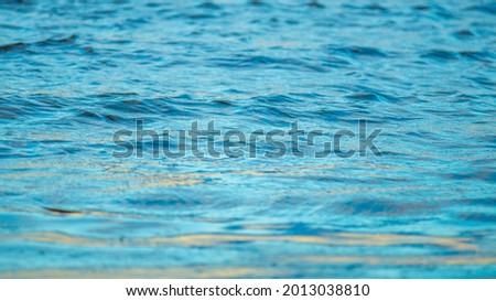 The texture of blue water with light waves