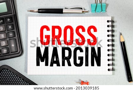 Business concept. Notebook with text PROFIT MARGIN sheet of white paper for notes, calculator, glasses, pencil, pen, in the white background