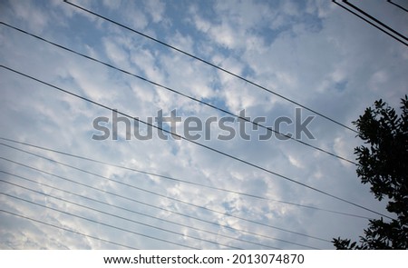 Wires pole with blue sky. electrical wires on a background. power cable with blue sky. Transmission Line cables.