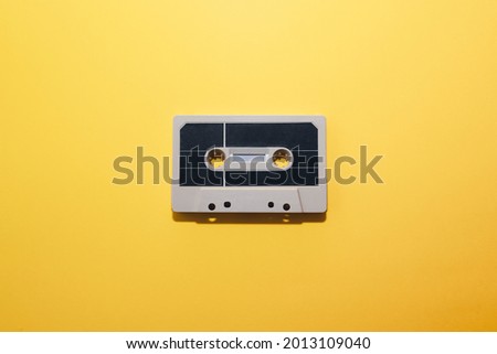 Audio cassette tape isolated on a yellow background