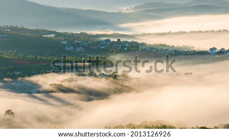 the rural scenery in Vietnam with magical of the light covering fog at the sunrise