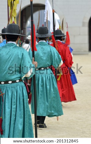 Row of armed guards in ancient traditional soldier uniforms in the old royal residence, Seoul, South Korea 