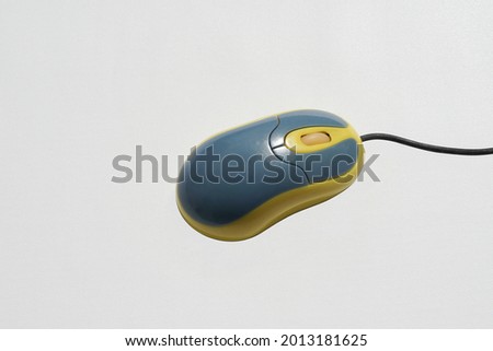 Blue yellow computer mouse on a white background
