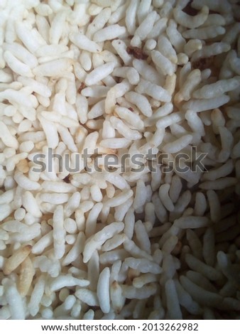Puffed rice and popped rice, are types of puffed grain made from rice commonly eaten in the traditional cuisines of Southeast Asia. selective focus, selective focus on the subject and  background blur