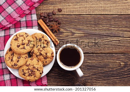 Top view on cup of coffee and plate with chocolate cookies Royalty-Free Stock Photo #201327056