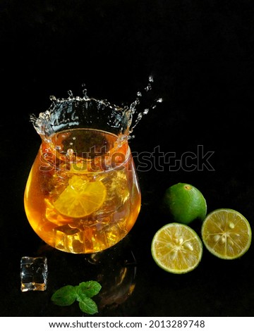 Lime juice splashes from the glass